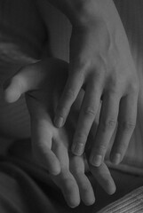 Body part detail: hands gently touching skin