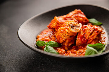 Stuffed cabbage tomato sauce with beans meat, cabbage, fresh delicious gourmet food background on the table rustic food top view copy space