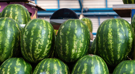 Lots of watermelons in the city market.