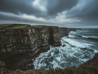 Dramatic coastal scenery shows Ireland's rugged cliffs and crashing waves under a stormy sky, creating a powerful seascape.