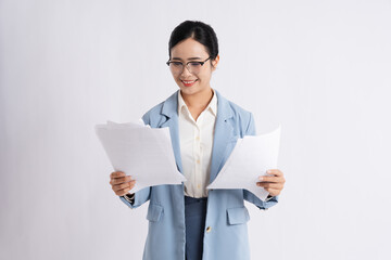 Professional woman reviewing documents in a light blue suit against a plain white background