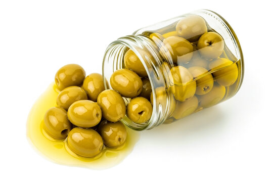 Green olives in a jar spilled on white background closeup