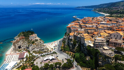 Aerial view of Tropea, a charming town perched on a cliff overlooking the Tyrrhenian Sea in Calabria, Southern Italy, featuring the iconic Santa Maria dell'Isola sanctuary