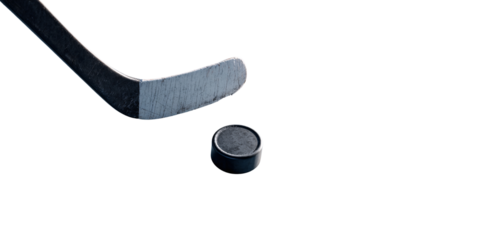 Ice hockey stick and puck on black background, showcasing the sports equipment and the intensity of the game Concept of competition, action, and winter sports