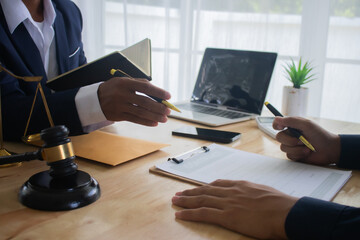 Lawyer at desk in office with legal documents and hammer, giving advice on justice, contracts, divorce, finances, judgments, support, law, power, meetings, courtroom, advice.