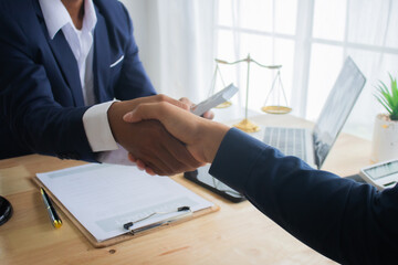 Lawyer at desk in office with legal documents and hammer, giving advice on justice, contracts,...