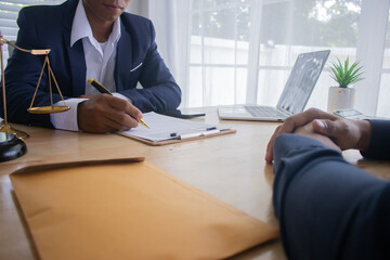Lawyer at desk in office with legal documents and hammer, giving advice on justice, contracts,...
