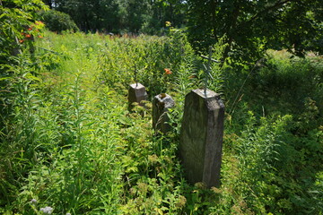 old cracked cross gravestone in cemetery