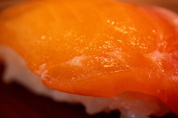 Close-up shot of freshly prepared salmon sushi served on a ceramic plate inside a traditional Japanese restaurant