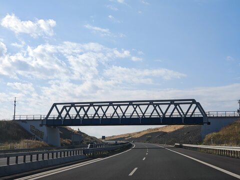 metal railway bridge over highway lanes in Czech republic Bohemia, between Slany and CHomutov-Louny cities  Europe