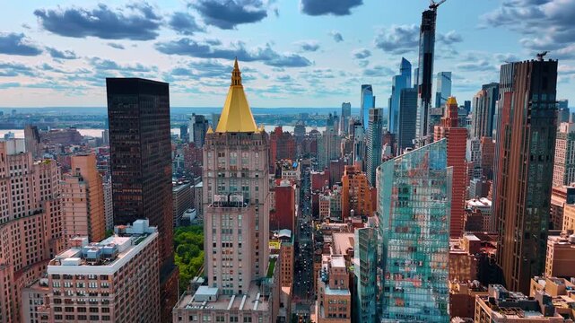 Approaching the tower of Life Insurance Company with the golden top. Panorama of New York under cloudy sky.