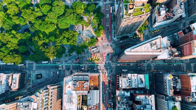 Cars move by the Fifth Avenue near the Madison Park and Flatiron building. Top perspective on the lively neighborhood of New York, USA.