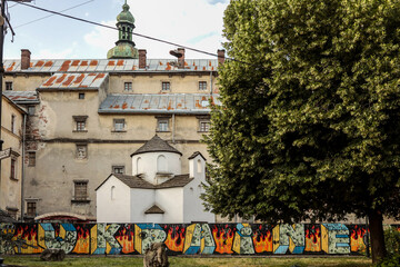 Old monastery wall with graffiti reading 