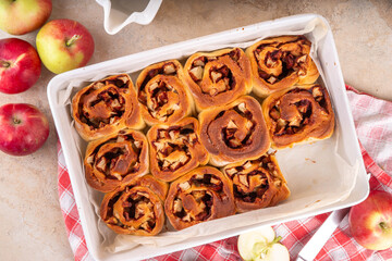 Apple cinnamon roll, sweet cinnabon buns with apple filling. Viral apple pie rolled buns, on beige...