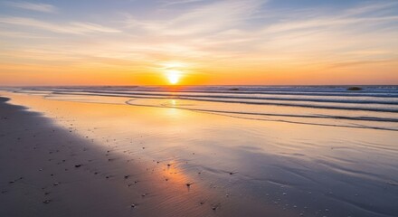 Fototapeta premium Serene sunset over a tranquil beach, reflecting golden hues in the calm ocean waters.