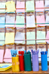 Pastel Kau Cim fortune sticks on table with ancient Thai - Chinese prediction board. Vertical shot...