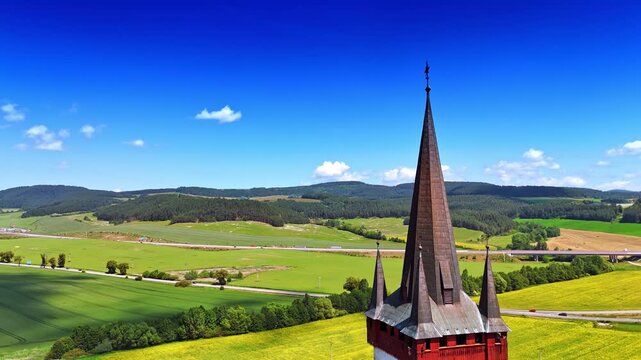 Footage at the steeple of the old church. Aerial perspective on the picturesque countryside in Slovakia.