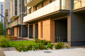 modern apartment building exterior with landscaped garden and pathway emphasizing urban living....