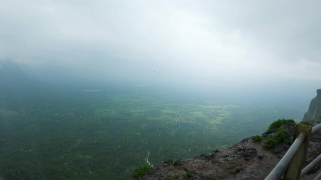 4K shot of reverse waterfall at Naneghat in Maharashtra, India during the monsoon season. Waterfall flows in reverse due to the strong winds in Sahyadri hills. Natural background with copy space.
