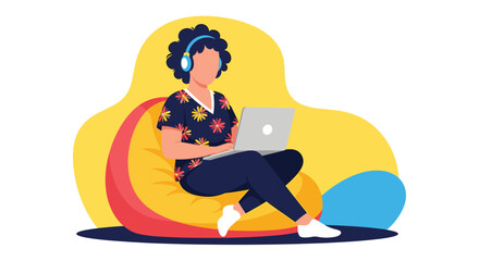 A young woman wearing headphones comfortably works on her laptop while sitting on a beanbag chair in a casual, relaxed home setting.