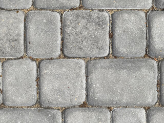 Exploring the texture and patterns of an old cobblestone path in sunlight