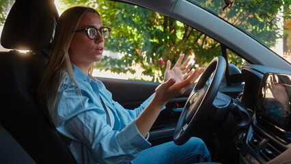 Dissatisfied angry Caucasian woman female girl driving car auto automobile conflict problem jam...