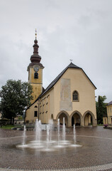 water fountain in front of church in historic downtown of tarvisio italy europe (european travel...