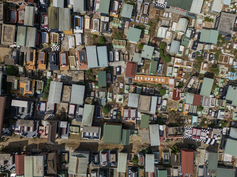 Aerial view of a densely packed cemetery filled with colorful tombstones and mausoleums under the bright sun, Pleiku, Gia Lai, Vietnam.