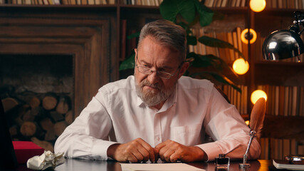 Confident successful old Caucasian man male mature takes off glasses looking at camera folded hands...
