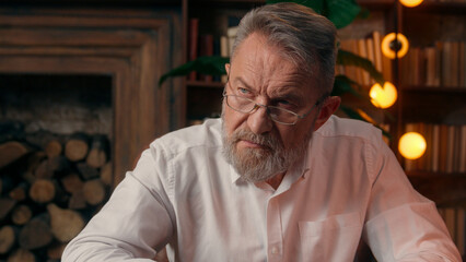 Confident successful old Caucasian man male mature takes off glasses looking at camera folded hands...