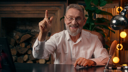 Confident successful old Caucasian man male mature takes off glasses looking at camera folded hands...