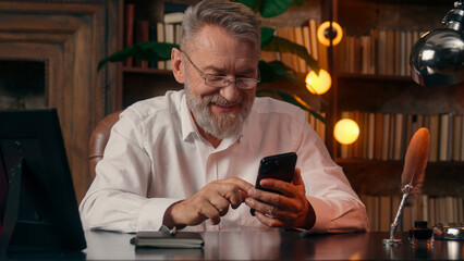 Confident successful old Caucasian man male mature takes off glasses looking at camera folded hands...