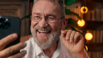 Confident successful old Caucasian man male mature takes off glasses looking at camera folded hands...