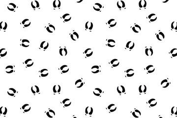 Scatter seamless pattern with black raindeer footprints on a transparent background for wrapping, textile or fabric