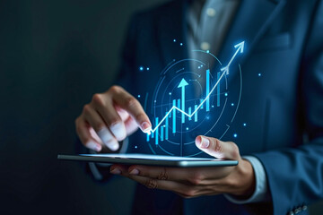 Businessman holding tablet with stock finance candlestick bar chart graph blue glowing floating