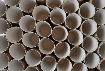 View of cardboard packages from above.An even row of empty cylinders made of recycled cardboard....