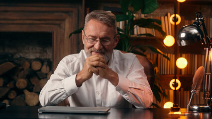Confident successful old Caucasian man male mature takes off glasses looking at camera folded hands...