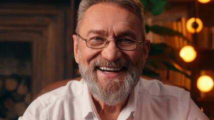 Confident successful old Caucasian man male mature takes off glasses looking at camera folded hands...