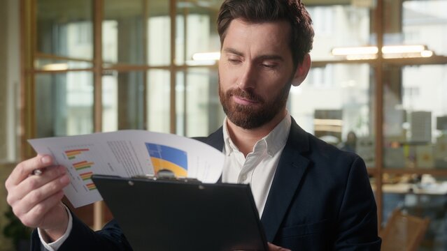 Business man Caucasian thoughtful male businessman reading document contract in office bank employee sign insurance successful deal smiling happy middle-aged guy contractor manager consider project