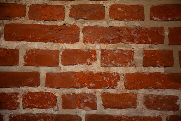 Irregular historic brickwork forming a vintage red masonry surface
