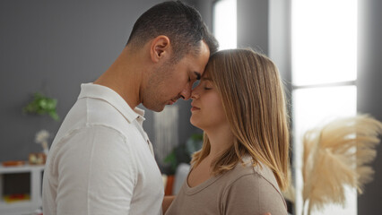 Couple embracing lovingly in cozy apartment living room capturing heartwarming relationship between man and woman amidst warm indoor decor enhancing intimate atmosphere