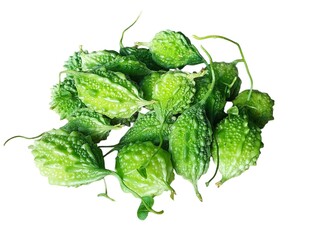 Pile of fresh green bitter melons with textured bumpy skin and delicate stems
