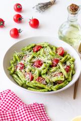 Pasta casarecce with pesto sauce, tomatoes and cheese. Italian cuisine. Vegetarian food.
