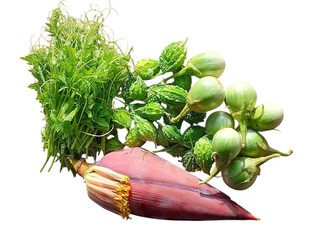 Fresh bunch of green vegetables including bitter melon small eggplants and a banana blossom...