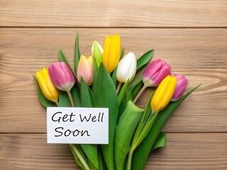 A bouquet of pink yellow and white tulips with a get well soon card on wood image