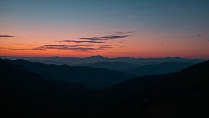 Obraz premium Mountain range silhouettes at sunrise.