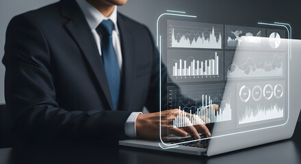 A professional analyzes complex digital data projections on a sleek laptop, showcasing advanced technological interaction.