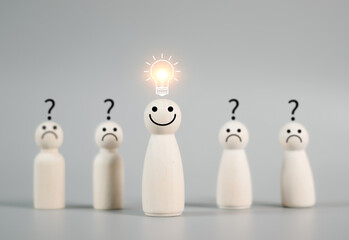 Smiley wooden human with light bulb and others human with question mark for creative thinking and problem solving solution concept.