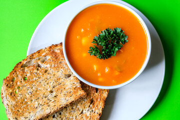 A Bowl Of Healthy Vegetable Soup Garnished With Parsley And Served With Toasted Bread