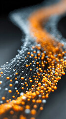 An abstract stream of glowing orange and blue data points flows across a dark surface, symbolizing communication or digital transfer